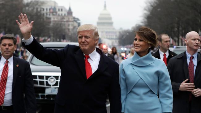 US President Donald Trump waves as he walks with first lady Melania Trump during the inauguration parade on Pennsylvania Avenue in Washington following swearing-in ceremonies on Capitol Hill. Picture: AFP