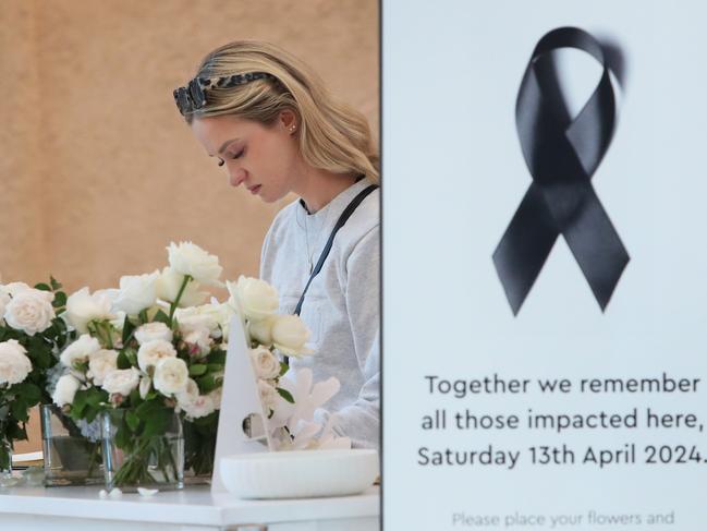 SYDNEY, AUSTRALIA - APRIL 19: A shopper signs a condolence book during the re-opening of Westfield Bondi Junction shopping centre on April 19, 2024 in Sydney, Australia. The Westfield Bondi Junction shopping centre re-opened for business on Friday following a stabbing attack on April 13, 2024 that killed seven, including the offender.  (Photo by Lisa Maree Williams/Getty Images)