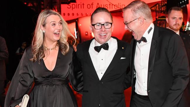 Jodie Haydon and her partner, Prime Minister Anthony Albanese flank former Qantas chief Alan Joyce at the airline’s 100th anniversary gala dinner. Picture: Getty Images