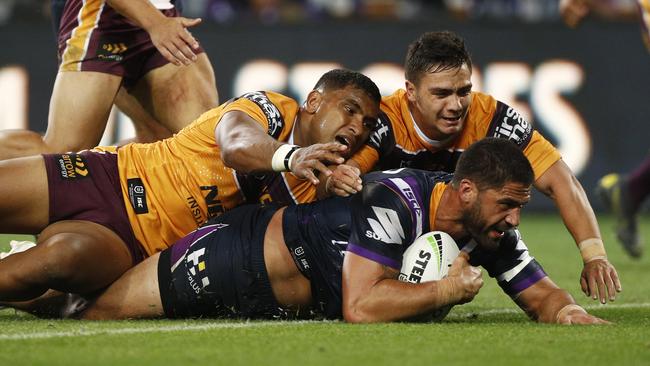 Tevita Pangai Jr and Kodi Nikorima fail to stop Jesse Bromwich from scoring. Picture: AAP Image/Daniel Pockett