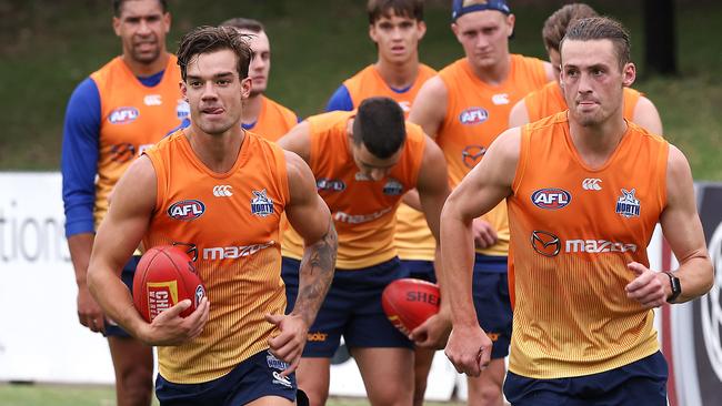 AFL. North Melbourne return to training for the 2021 AFL season.Jy Simpkin on the left does a running drill. Picture : Ian Currie