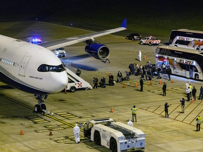 Passengers from the Australian cruise ship Greg Mortimer, get on a plane to be flown to Australia at the international airport in Montevideo, Uruguay. Picture: AP