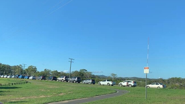 Cars queue at Gladstone's Blain Drive sporting complex for COVID testing on Tuesday, March 30.