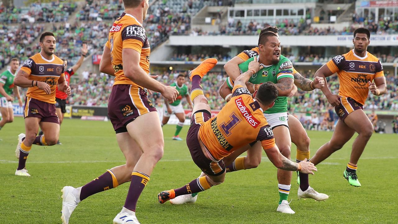 Joey Leilua sends Broncos flying on the way to the tryline. Picture: Mark Kolbe/Getty Images