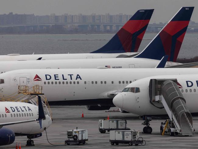 (FILES) Delta Airlines passenger aircrafts are seen on the tarmac of John F. Kennedy International Airpot in New York,on December 24, 2021. Eleven airline passengers and crew were hospitalized August 29, 2023 following severe turbulence on a Delta flight from Milan to Atlanta, the US-based airline said. (Photo by Yuki IWAMURA / AFP)