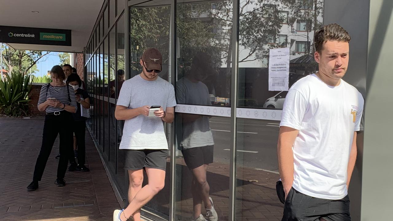 People line up outside Centrelink in Hornsby, with some waiting as long ...