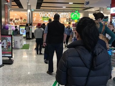 Shoppers queue at Woolworths in Melbourne. Picture: Leo Stubbing on Twitter.