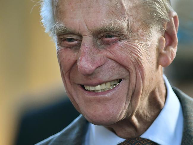 (FILES) In this photograph taken on April 9, 2014, Britain's Prince Philip, Duke of Edinburgh smiles as he meets members of the Royal College of Organists to commemorate their 150th anniversary at St. George's chapel at Windsor Castle in Windsor west of London. Prince Philip, the 96-year-old husband of Queen Elizabeth II, has been admitted to hospital as a "precautionary measure" for treatment of an infection, Buckingham Palace said on June 21, 2017. The infection arose from "a pre-existing condition", the palace said. The Duke of Edinburgh, who is to retire from public duties later this year, was admitted to hospital on Tuesday night.  / AFP PHOTO / POOL / BEN STANSALL