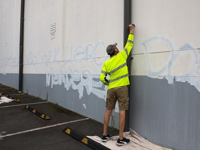 SYDNEY, AUSTRALIA : NewsWire Photos - JANUARY 30 2025; A council worker is seen working to remove the grafitti on the wall of the carpark at the Mount Sinai College in Maroubra as new anti-semitic graffiti plastered on property at in Sydney continues to suffer a spate of anti semitic attacks. Picture: NewsWire/ Gaye Gerard