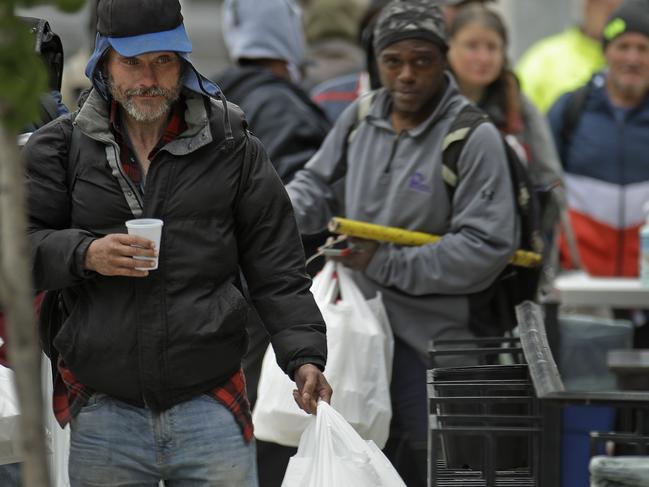 People receive free meals at a downtown restaurant. Picture: AP