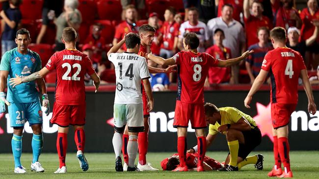 Jamie Young of the Roar is given a red card after colliding with Craig Goodwin of Adelaide United. Picture: James Elsby/Getty Images