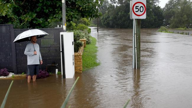 Sydney continues to be drenched in heavy rains causing flooding in local areas and the Warragamba Dam to overflow, sending millions of litres of water down the Nepean River to low lying areas like Emu Plains. Jim Hetherington watches as rising flood water threaten his home on River Rd.  Picture: Toby Zerna