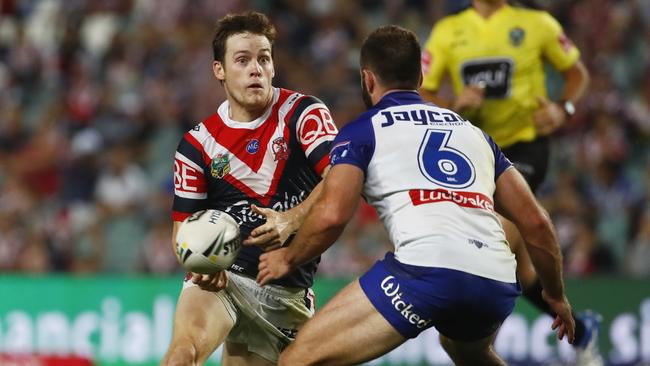 Luke Keary of the Roosters tries to evade Matthew Frawley of the Bulldogs during the Round 2 NRL match between the Sydney Roosters and the Canterbury-Bankstown Bulldogs at Allianz Stadium in Sydney, Friday, March 16, 2018. (AAP Image/Daniel Munoz) NO ARCHIVING, EDITORIAL USE ONLY