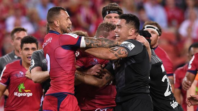 Quade Cooper (left) tussles with Crusaders star Codie Taylor.