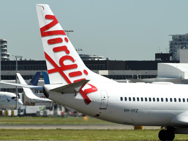 Virgin Australia aircraft a Sydney Airport in Sydney, Thursday, March 19, 2020. Qantas has suspended all international flights and will stand down two-thirds of its 30,000-strong workforce until the end of May. (AAP Image/Joel Carrett) NO ARCHIVING