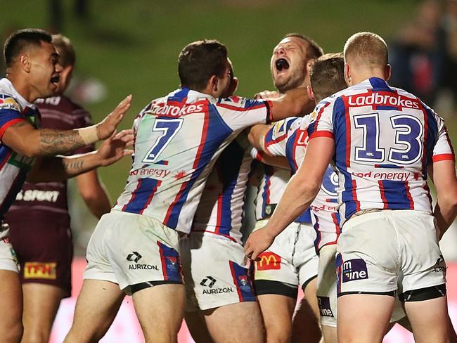 The Knights celebrate their matchwinner — set up by Ponga. Picture: Getty Images