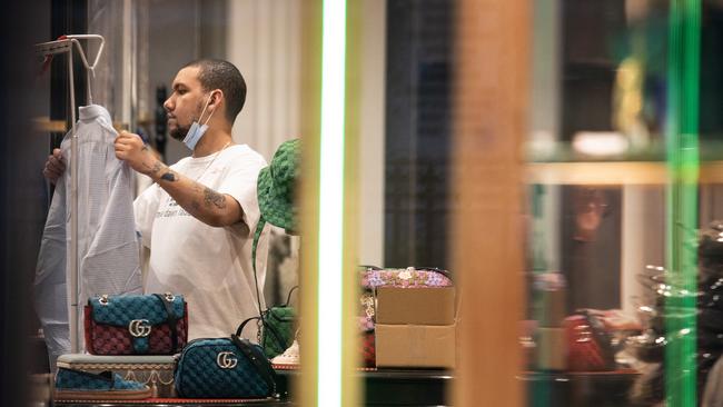 A Gucci staff member prepares for opening again ahead of the fourth lockdown in Melbourne. Picture: NCA NewsWire / Sarah Matray