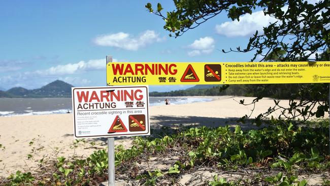 A sign at the southern end of Palm Cove beach alerts visitors to a recent croc sighting in the area. Picture: PETER CARRUTHERS