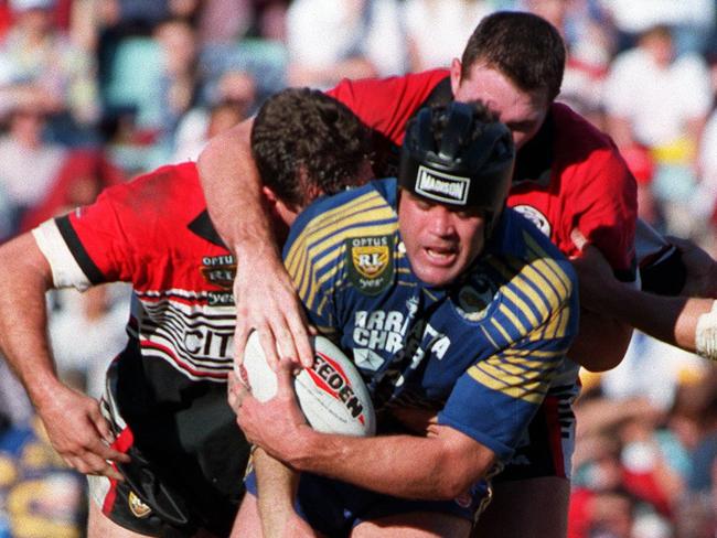 Peter Johnston dishes out a bit of punishment with the ball for Parramatta.