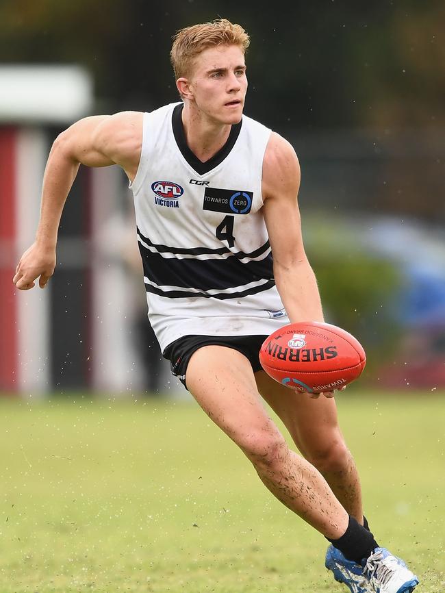 Northern Knights midfielder Tom McKenzie gets a handball away. Picture: Getty Images.