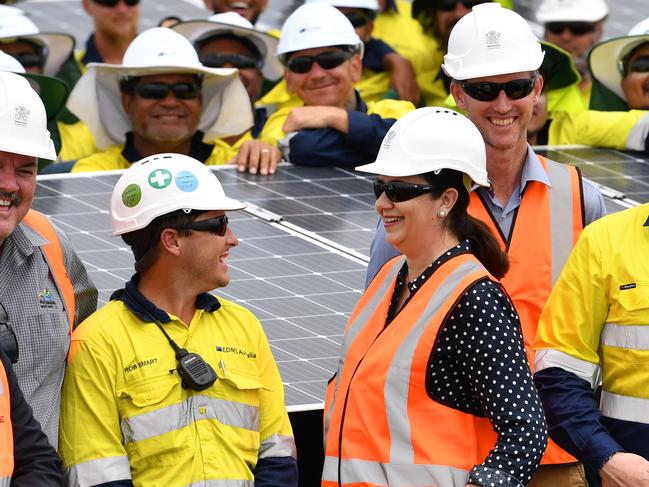 Queensland Premier Annastacia Palaszczuk (centre) is seen talking to workers as she inspect's the Clare Solar Farm project near the North Queensland town of Ayr during the Queensland Election campaign on Sunday, November 12, 2017. Premier Palaszczuk announced if re-elected her government would commit $151.6 million to the expansion of large scale renewable energy generation. (AAP Image / Darren England) NO ARCHIVING