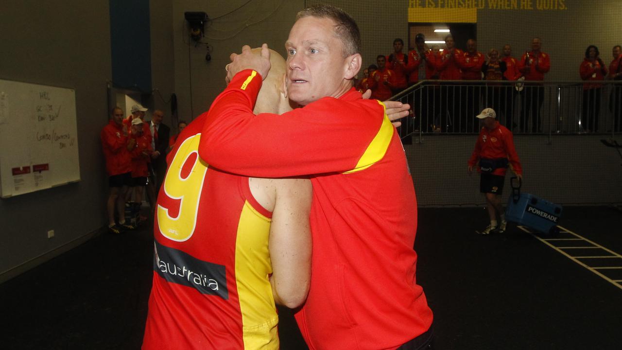 Gary Ablett and Guy McKenna celebrate after a Gold Coast win.