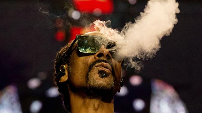 Snoop Dogg blows smoke as he performs on stage in March this year. (Photo by Anna KURTH / AFP)