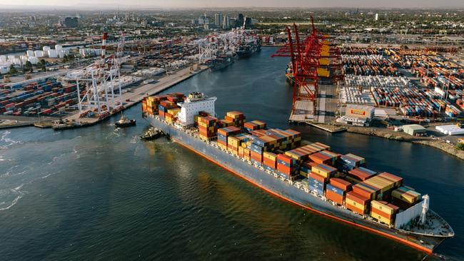 A container ship is guided at the Port of Melbourne’s Swanson Dock. The port's chief executive Saul Cannon says rail will have to play a bigger role in moving goods to and from wharves. Picture: Port of Melbourne