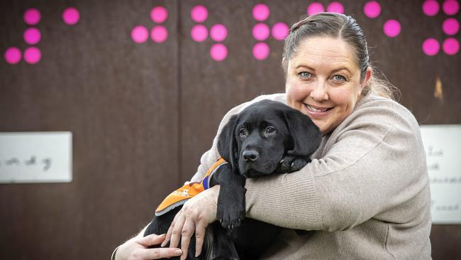 Guide Dog instructor Kim Ryan with Quasi (12 weeks old) at the Guide Dog Memorial, Hobart. Picture Chris Kidd