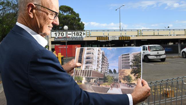 Unley Mayor Michael Hewitson shows how the plans would transform an area currently used as an open-air car park. Picture: Tricia Watkinson