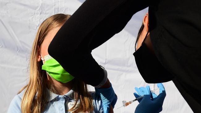 A child receives a dose of Pfizer's Covid-19 vaccine in California. Australia is considering vaccines for children. Picture: AFP