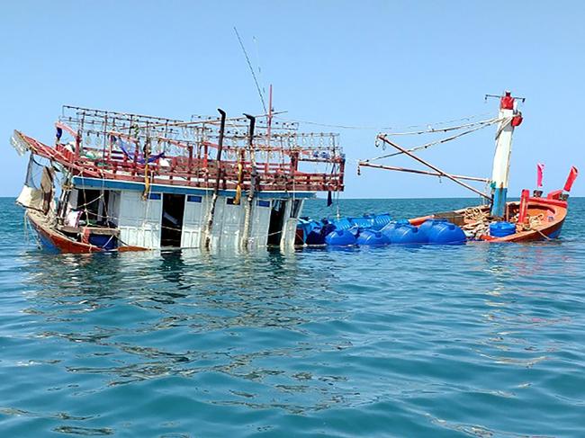 This handout photo from the  by the Port Douglas Marine Rescue taken and released on August 27, 2018 shows an abandoned fishing boat in the Daintree near Cape Kimberley in Queensland. - Dozens of foreigners were believed to be on the run August 27 in an Australian mangrove rainforest after their suspected illegal fishing boat ran aground in crocodile-infested waters. (Photo by Handout / Port Douglas Marine Rescue / AFP) / RESTRICTED TO EDITORIAL USE - MANDATORY CREDIT "AFP PHOTO / PORT DOUGLAS MARINE RESCUE" - NO MARKETING NO ADVERTISING CAMPAIGNS - DISTRIBUTED AS A SERVICE TO CLIENTS --- NO ARCHIVES ---