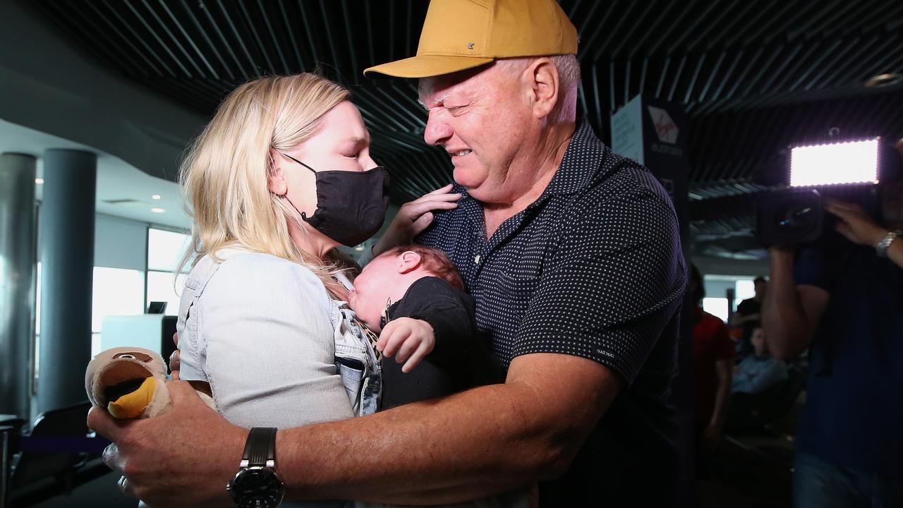 Grandfather Cole meets his grandson Ted for the first time, with daughter Lauren, at Brisbane Airport. Picture: Jono Searle/Getty Images