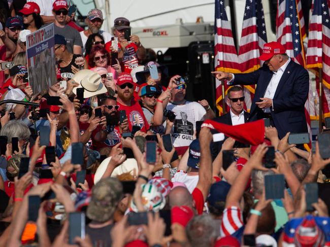 Former US President Donald Trump greets the crowd as he arrives at a campaign event at Butler Farm Show Inc. in Pennsylvania. Moment later Trump was shot at. Picture: AFP