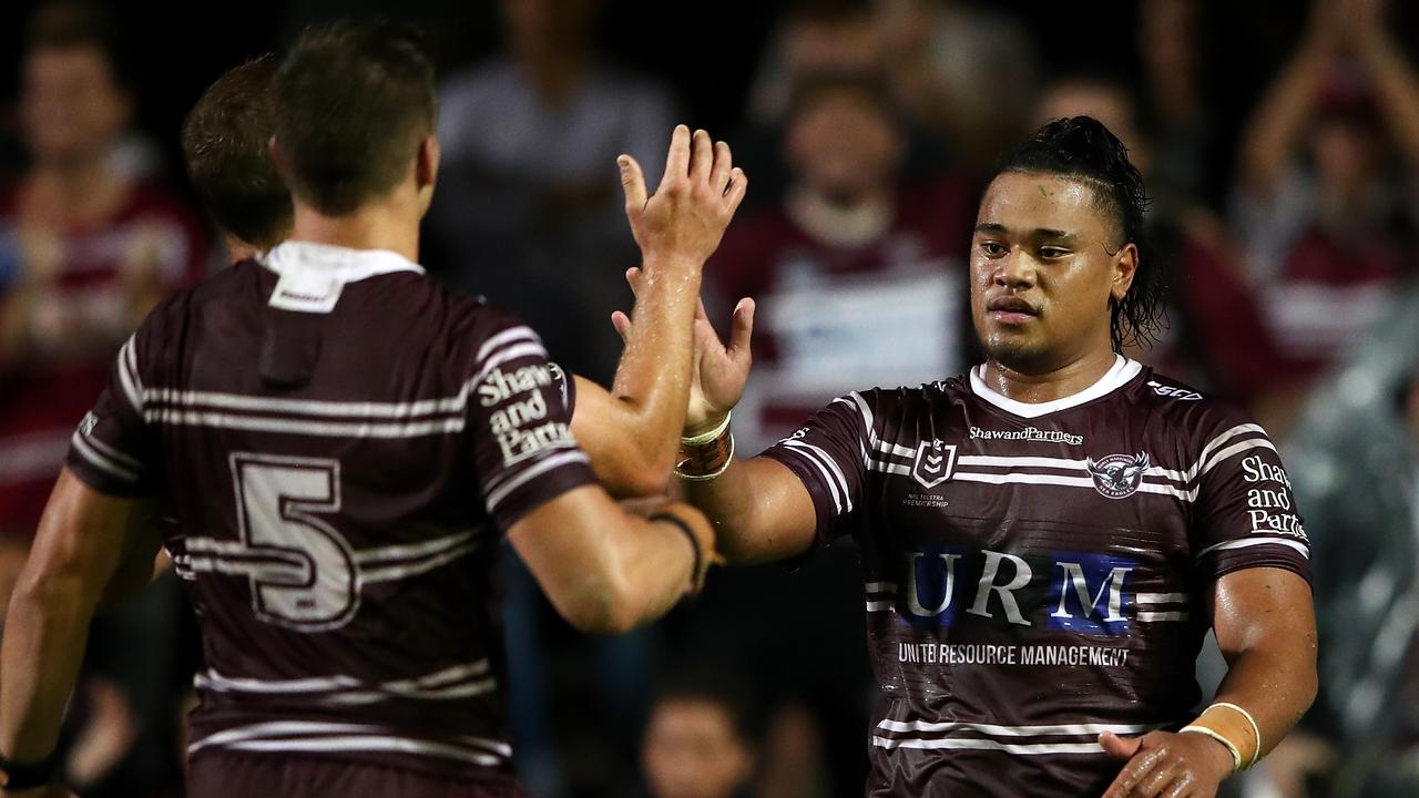 Moses Suli of the Sea Eagles is congratulated by teammates