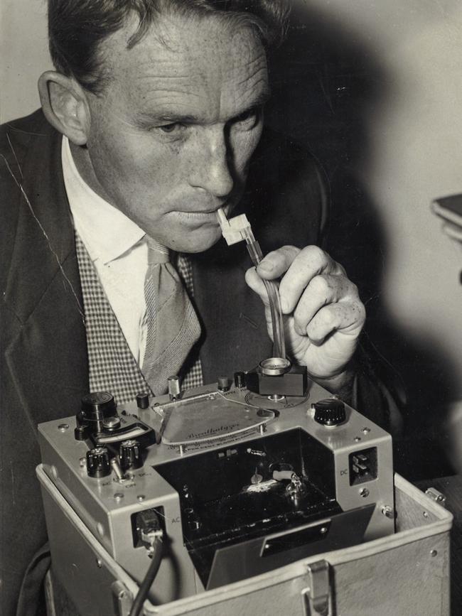 A reporter tries the breathalyser at Russell St in 1961.