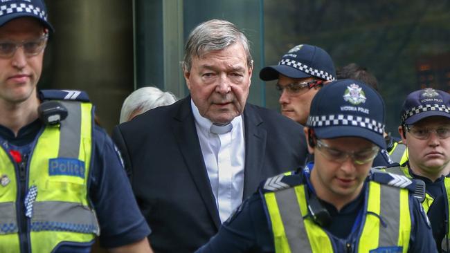 Cardinal George Pell leaves court during his trial in Melbourne.