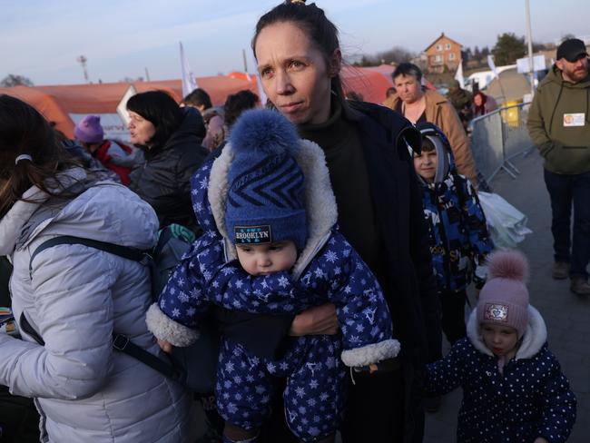 A mother arrives with her children in Poland from war-torn Ukraine. Dozens of children have been killed in the invasion. Picture: Getty Images