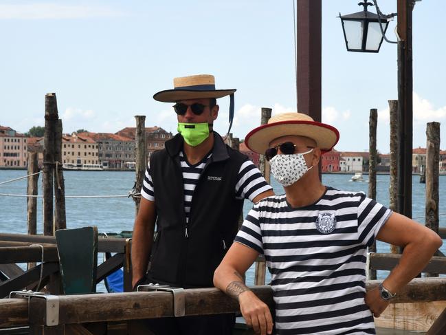 Gondoliers wearing protective face masks in Venice. Tourists could soon be back in the famous city. Picture: AFP