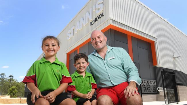 St Ann's School opened in Redbank Plains on Wednesday. Students Emma Paratene and Oliver Chiarelli with principal Sonny Smith.