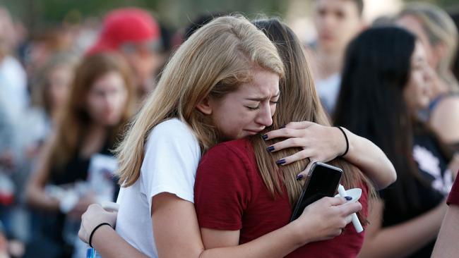 Students comfort each other before a candlelight vigil for victims of the Marjory Stoneman Douglas High School shooting. Picture: AFP
