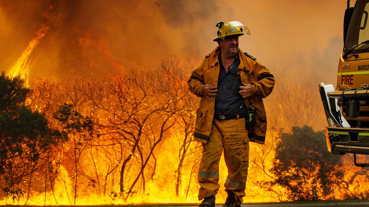 Firefighters on scene south of Peregian Beach as water bombing helicopters were called in to fight the wild bushfire. Photo Lachie Millard