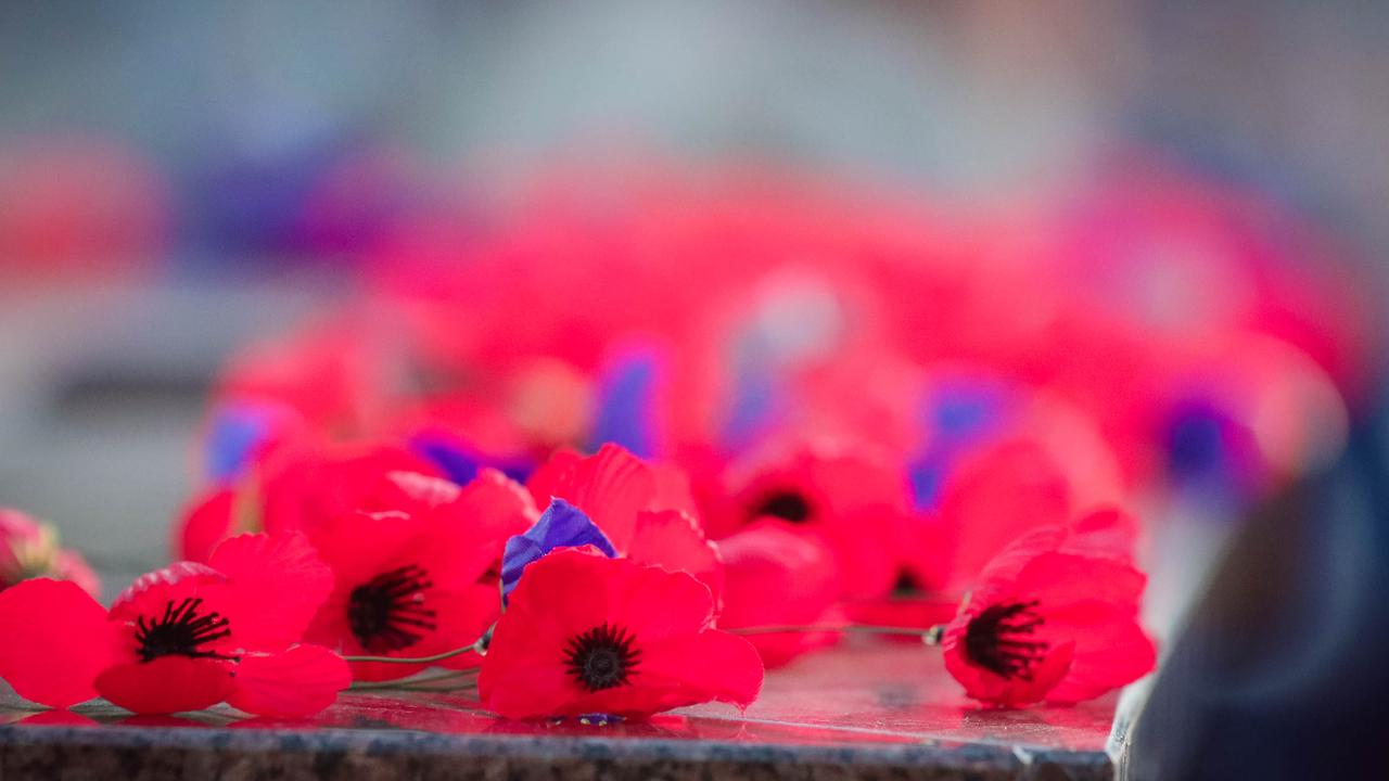 Poppys being laid at The Dawn Service at Darwins Cenotaph commemorating ANZAC Day 2021. Picture Glenn Campbell