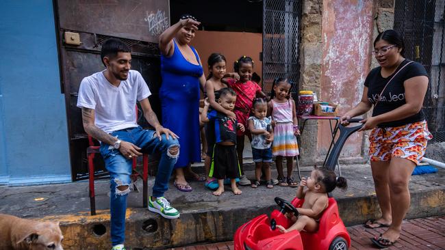 A family living in the suburb of San Felipe in Panama's old town have been rebuilding since a fire tore through their building in 2014. More than 30 people live in the home, including Dexter (white T-shirt), Lola (in red car), Coral (blue dress), Sophia, 1, Atalia, 7, Sara, 4, (pink dress), Blasy, Isabella (red dress). Picture: Jason Edwards