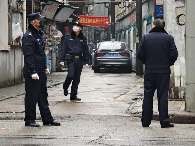 Police patrol a neighbourhood in Wuhan. Picture: Getty Images