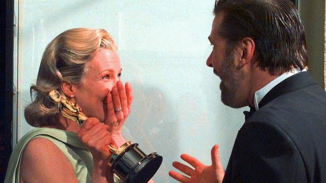 Kim Basinger and her then husband, Alec Baldwin, react backstage after she won the Best Supporting Actress Oscar.