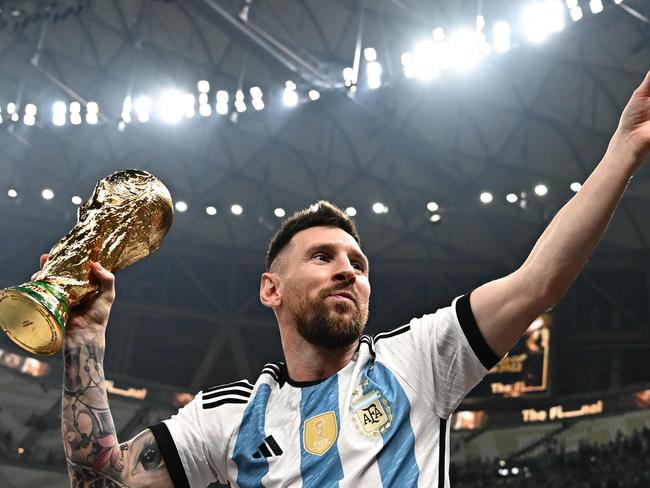 Argentina's captain and forward #10 Lionel Messi holds the FIFA World Cup Trophy following the trophy ceremony after Argentina won the Qatar 2022 World Cup final football match between Argentina and France at Lusail Stadium in Lusail, north of Doha on December 18, 2022. Lionel Messi says he will sign for Inter Miami in Spanish media interview, AFP reported on June 7, 2023. (Photo by Anne-Christine POUJOULAT / AFP)