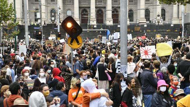 Protesters gather at State Parliament to rally against Australia Day. Picture: Jake Nowakowski