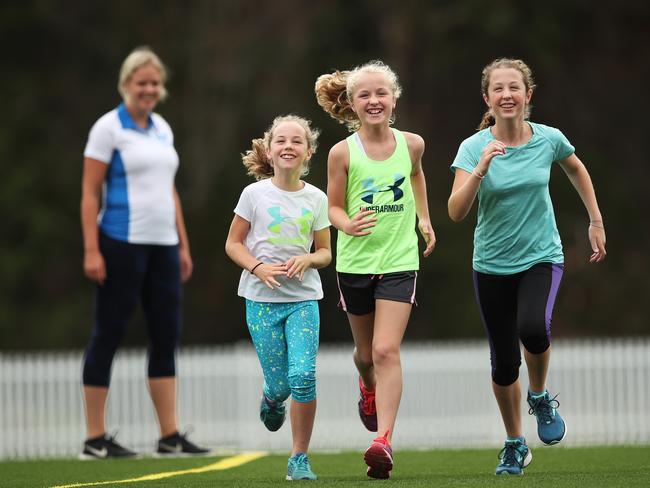 Claire Tompsett of North Shore running with sisters Phoebe 9, Heidi 11, and Mollie, 13, Arhens. Pictures. Phil Hillyard