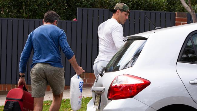 Cooper Cronk arrives home in Mosman with his left arm immobilised. Picture: Luke Drew